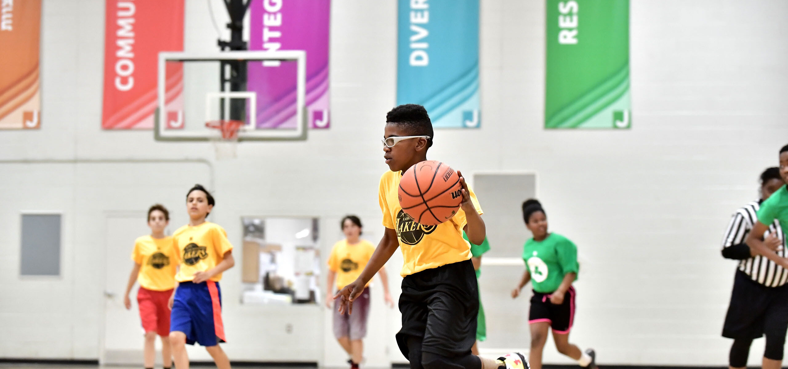 A group of teens playing basketball.