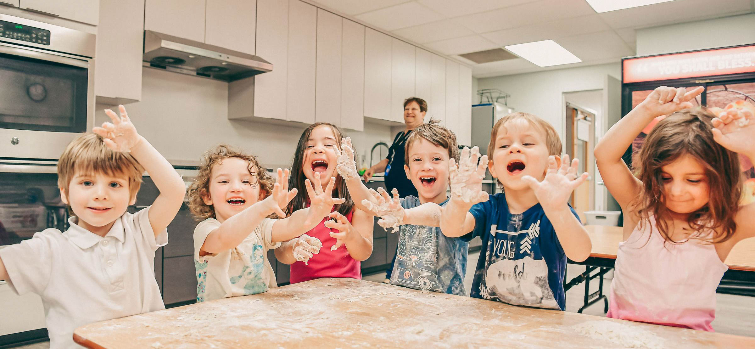 A group of kids in a kitchen.