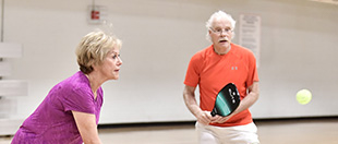A couple playing pickleball together.