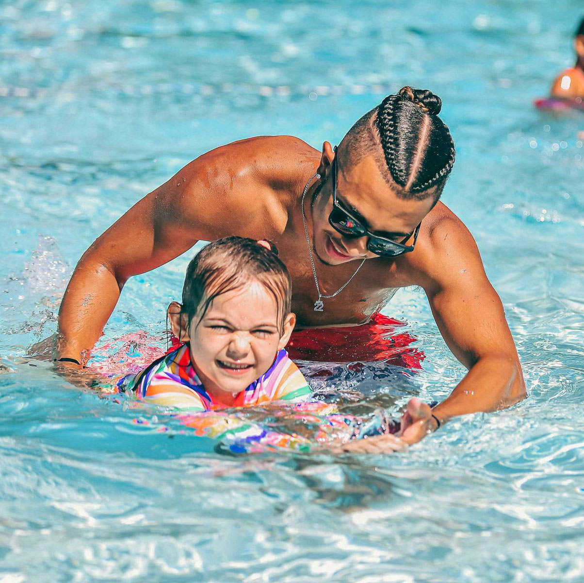 A child learning how to swim.