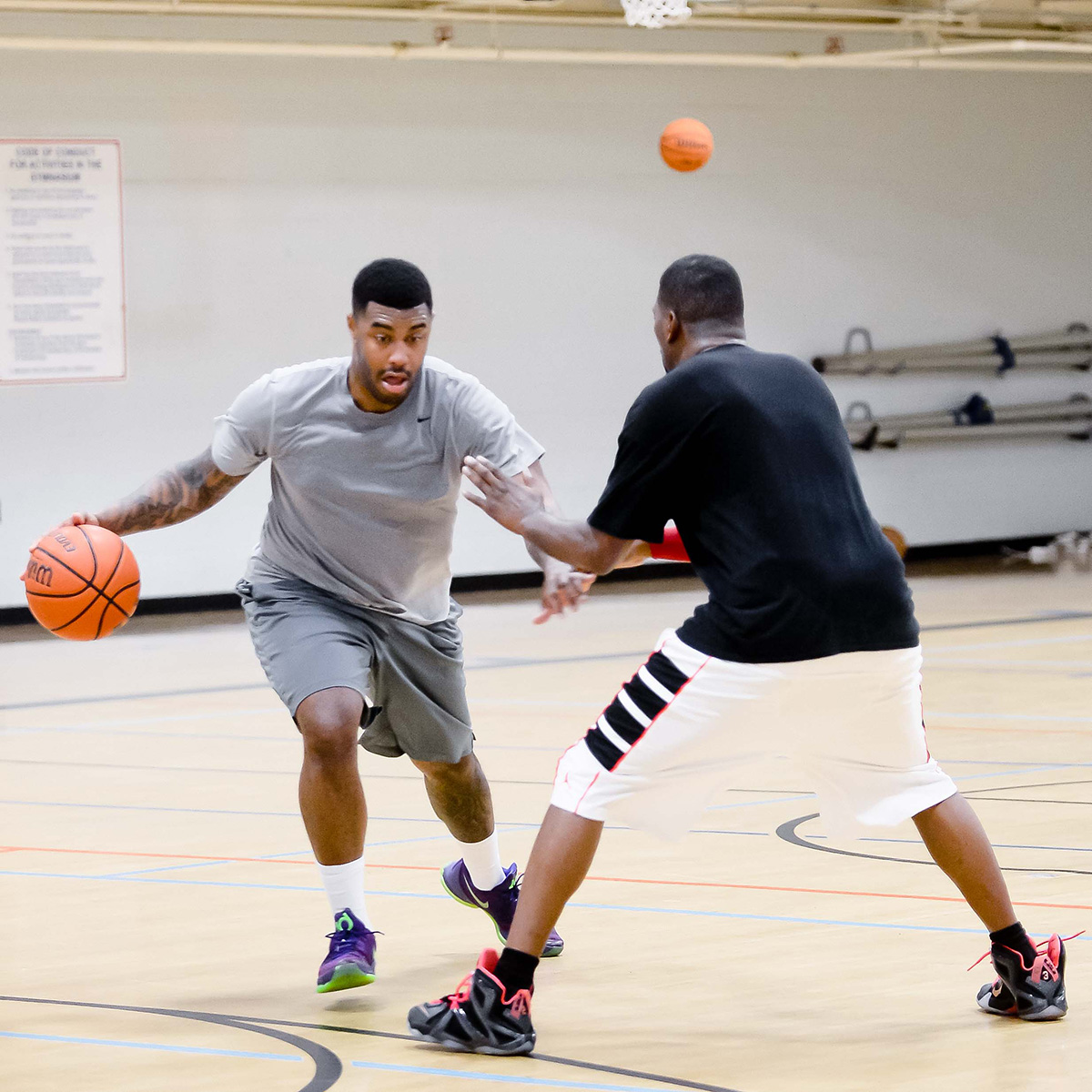 Two people playing basketball.