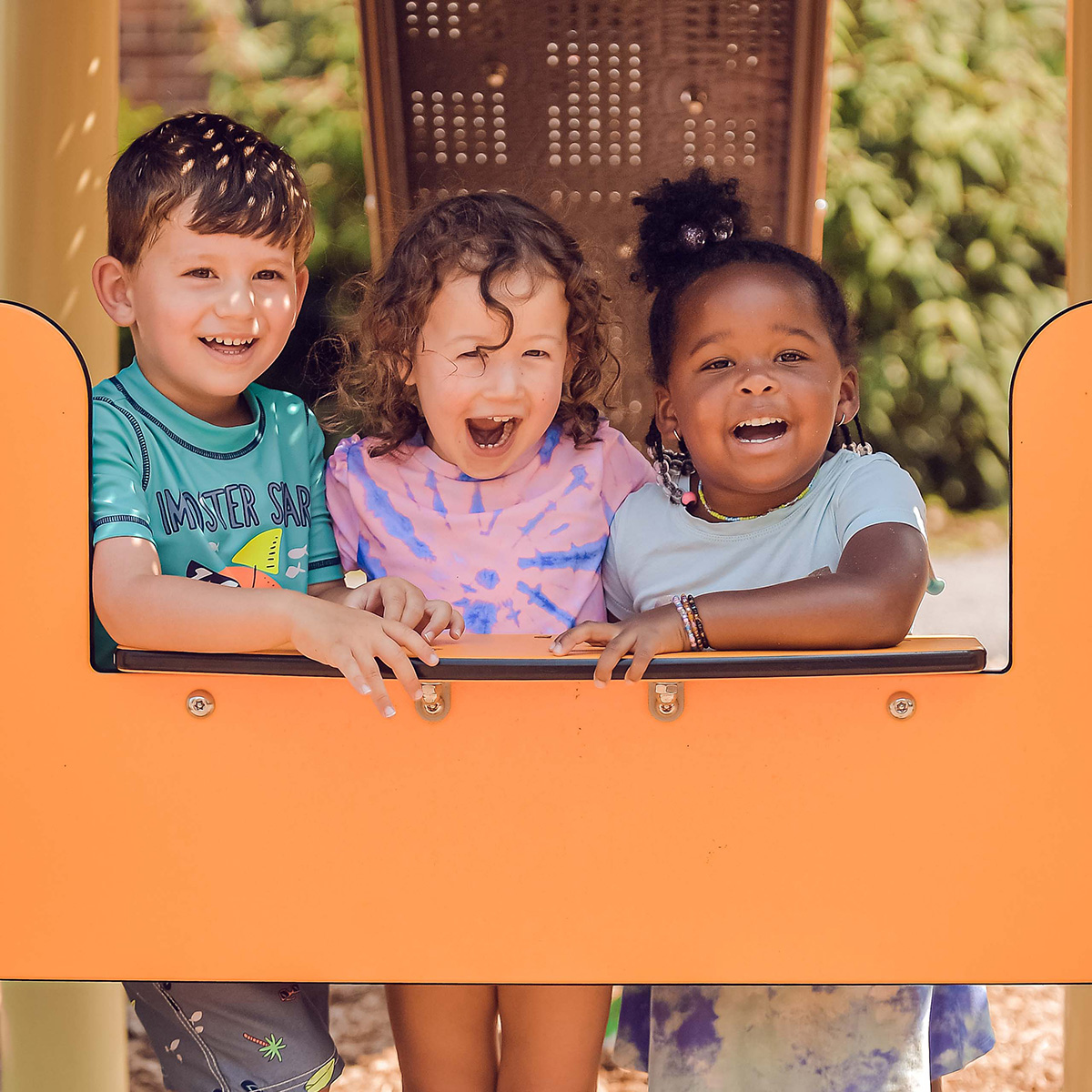 Three kids at a playground.