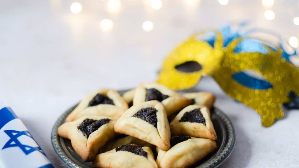 Photo with Hamentaschen, an Israeli flag and a mask