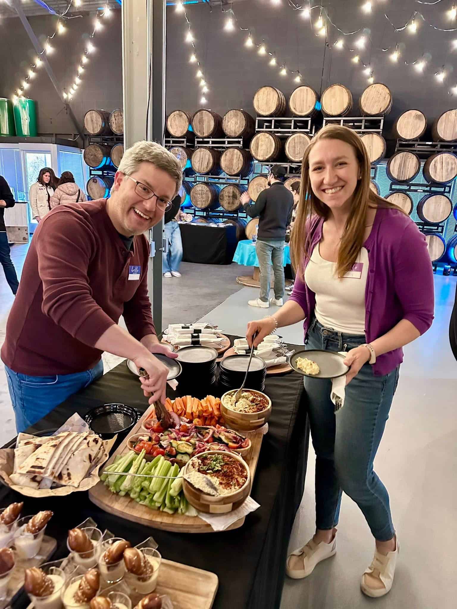 Man & woman smiling at buffet