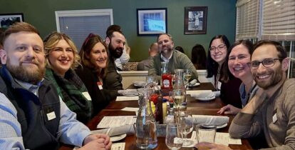 Smiling large group at table