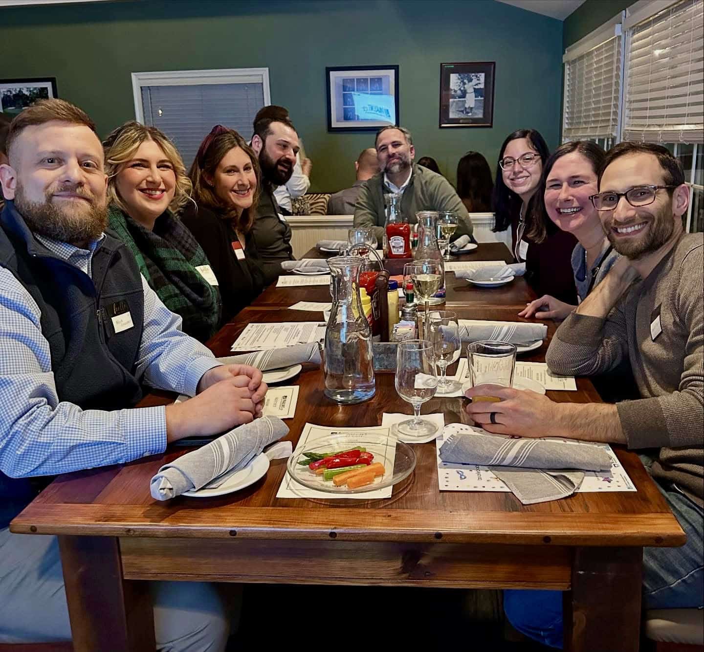 Smiling large group at table
