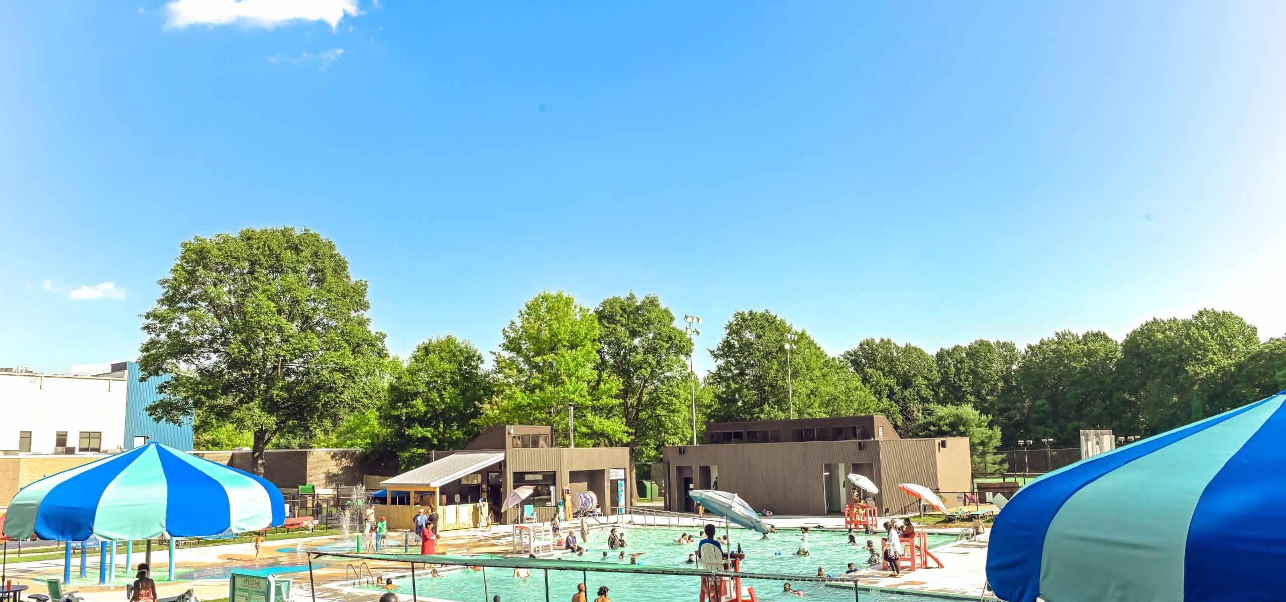 Outdoor pool and aquatics park at the JCC in Owings Mills with families swimming and relaxing