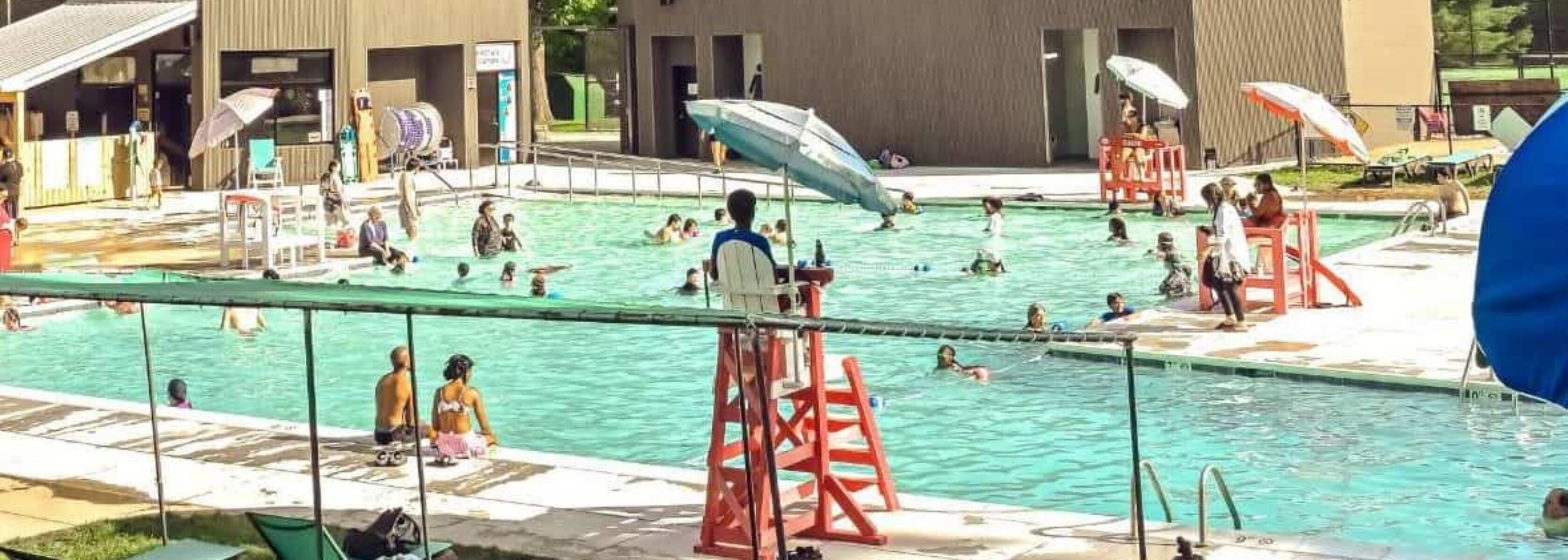 Outdoor pool and aquatics park at the JCC in Owings Mills with families swimming and relaxing